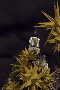 Low angle view of illuminated statue against sky at night