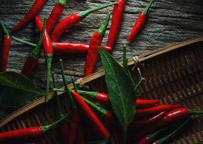 High angle view of red chili peppers in basket on table