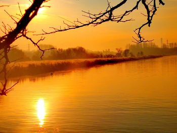 Scenic view of lake against orange sky