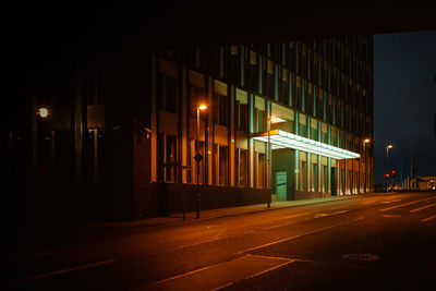 Illuminated city street at night