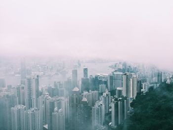 Aerial view of buildings in city against sky