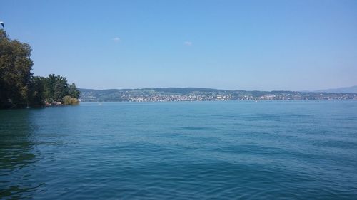 Scenic view of sea against clear blue sky