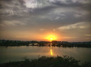 Scenic view of river at sunset