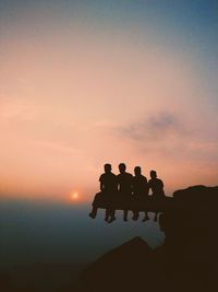 Silhouette people against sky during sunset