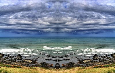 Scenic view of sea against cloudy sky