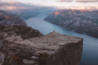 Unrecognizable man standing at cliff at preikestolen, norway