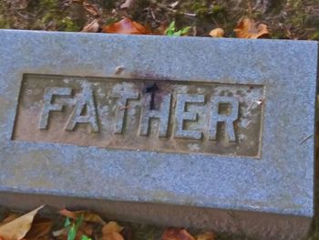 Close-up of text on stone at cemetery