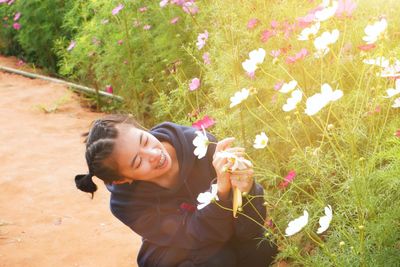 Portrait of smiling young woman on field