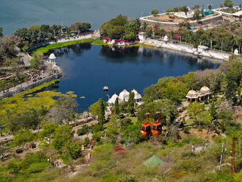 High angle view of trees and buildings by lake