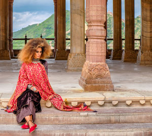 Full length of woman sitting outdoors