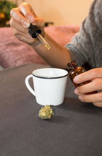 Man holding coffee cup on table