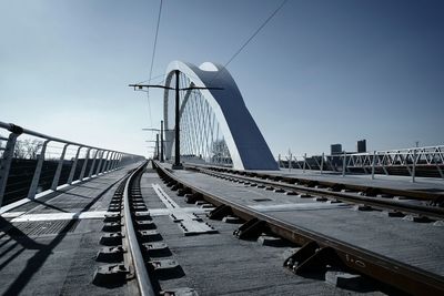 Railway bridge in city against sky