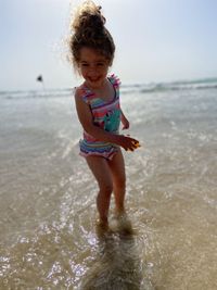 Full length of cute boy on beach