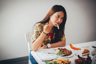 Young woman sitting on table