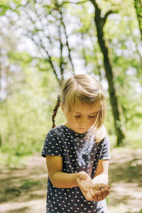 Girl standing in forest