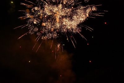 Low angle view of firework display at night