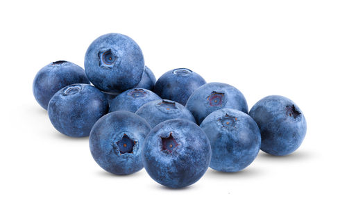 Close-up of blueberries against white background