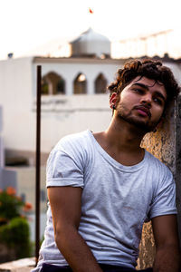 Portrait of young man looking away outdoors