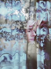 Digital composite image of woman with reflection on glass window