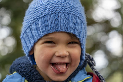 Close-up portrait of cute boy in snow