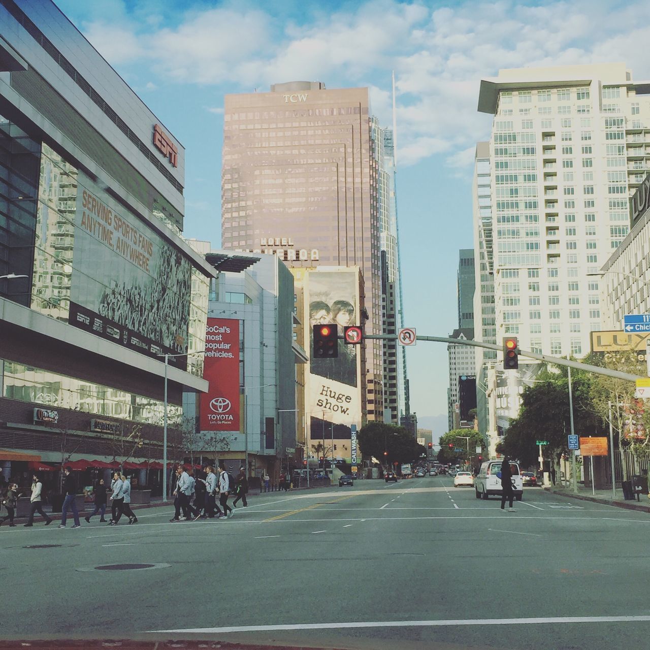 city, architecture, car, building exterior, skyscraper, built structure, city life, street, sky, city street, land vehicle, transportation, day, cloud - sky, outdoors, road, yellow taxi, no people, urban skyline