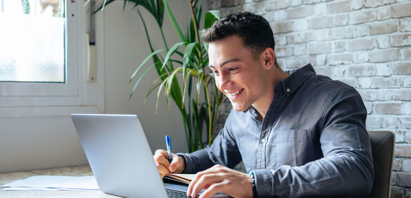 Young man using laptop at home