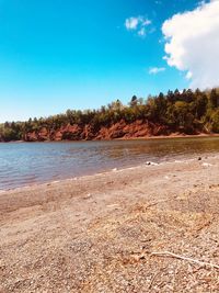 Scenic view of beach against blue sky