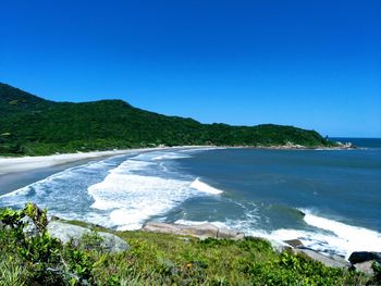 Scenic view of sea against clear blue sky