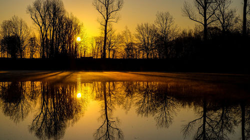 Scenic view of lake against sky during sunset