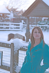 Portrait of teenage girl standing in snow