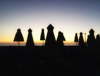 Low angle view of silhouette trees against clear sky