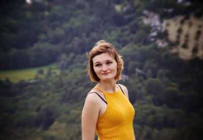 Smiling young woman standing outdoors