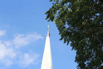 Low angle view of tower and tree against sky