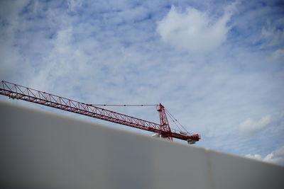 Low angle view of crane against sky