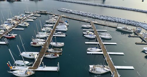 High angle view of sailboats moored at harbor
