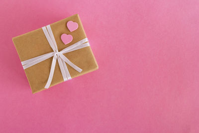 Close-up of paper box against pink background