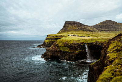 Scenic view of waterfall against sky