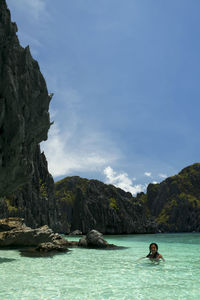 Scenic view of rocks in sea against sky