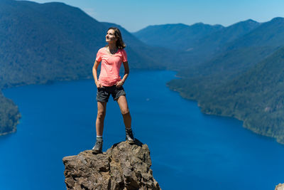 Full length of man standing on rock against mountain