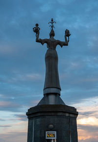 Low angle view of statue against cloudy sky