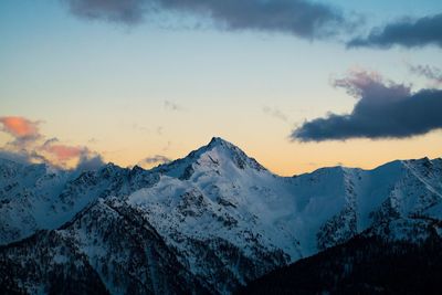 Scenic view of snowcapped mountains against sky during sunset