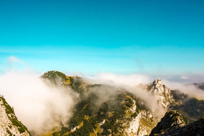 Scenic view of mountains against blue sky