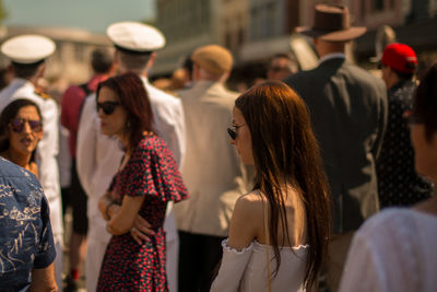 Rear view of women standing on street