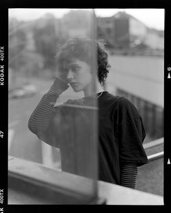 Young man looking through window