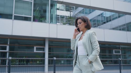 Young businesswoman talking on mobile phone in office
