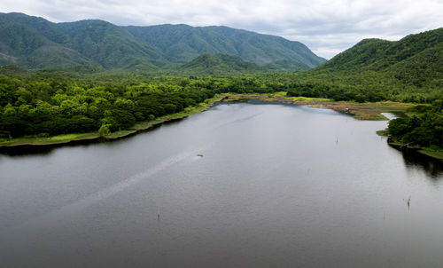 Scenic view of river amidst mountains against sky