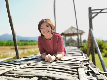 Portrait of a smiling young woman sitting outdoors