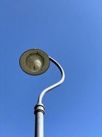 Low angle view of street light against clear blue sky