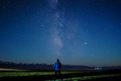 Full length of woman standing on field against sky