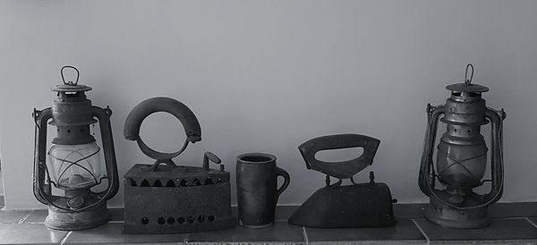 Close-up of objects on table against wall